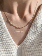 MCJ hidden message gold Morse code necklace spelling I LOVE YOU, showcasing the 22K e-coated gold finish for custom gifting[cite: 15].