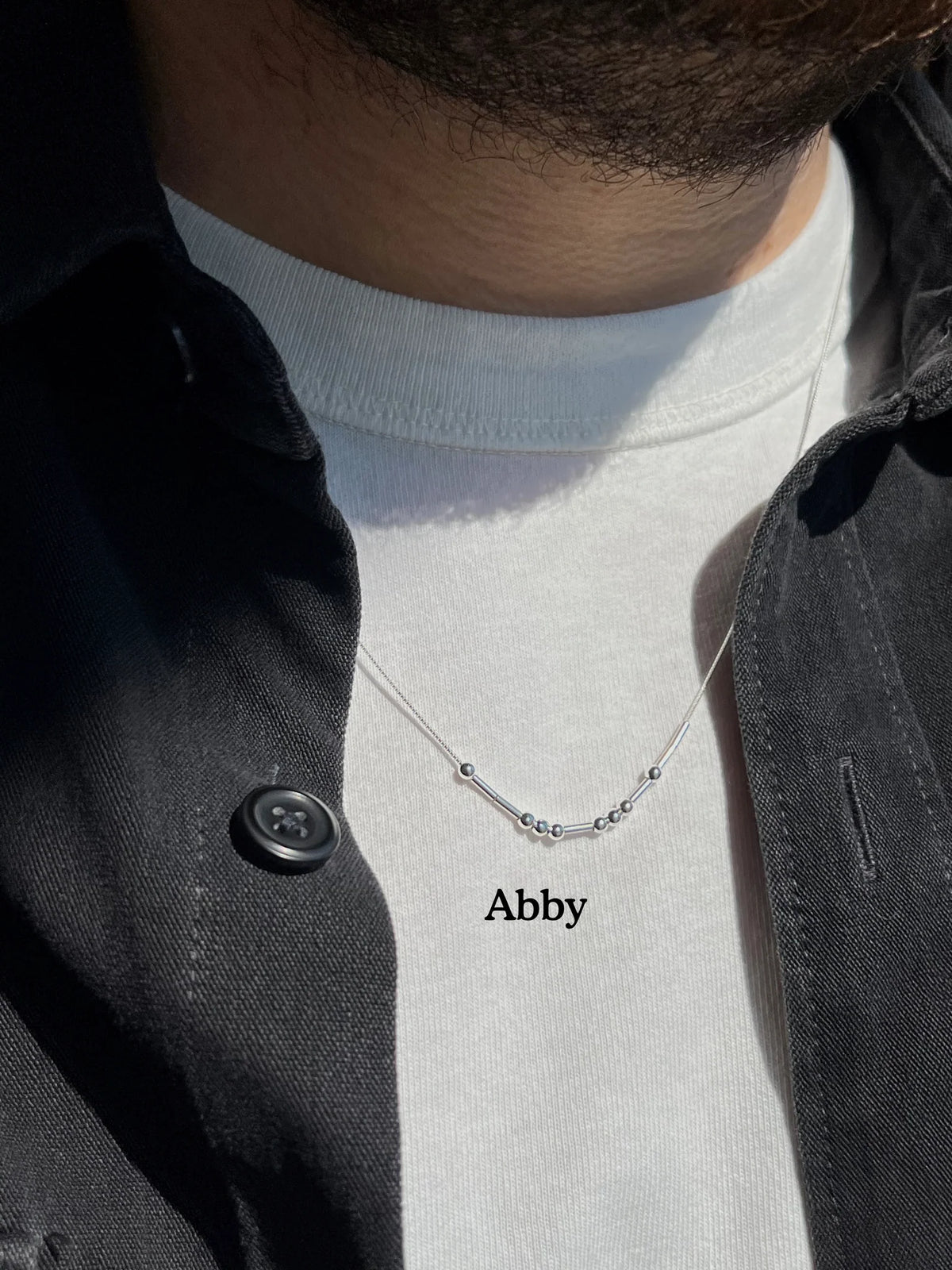 MCJ personalized silver Morse code name necklace spelling Abby, featuring an anti-tarnish rhodium finish on a unisex 18-20 inch chain
