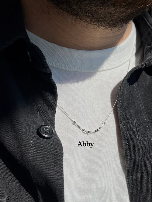 MCJ personalized silver Morse code name necklace spelling Abby, featuring an anti-tarnish rhodium finish on a unisex 18-20 inch chain