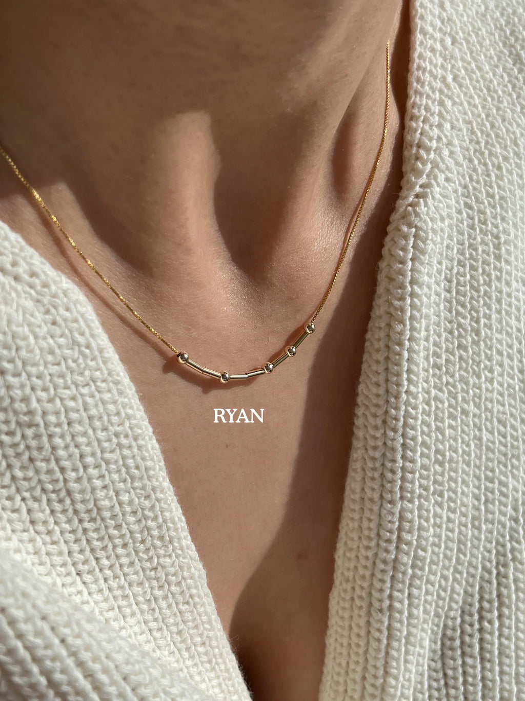 Unisex 22K gold plated custom Morse code necklace by MCJ spelling Ryan, showing minimal 4mm geometric beads[cite: 11].