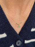 A minimalist 22K gold Morse code necklace featuring couple's initials and a bright green bezel-set anniversary birthstone charm[cite: 11].